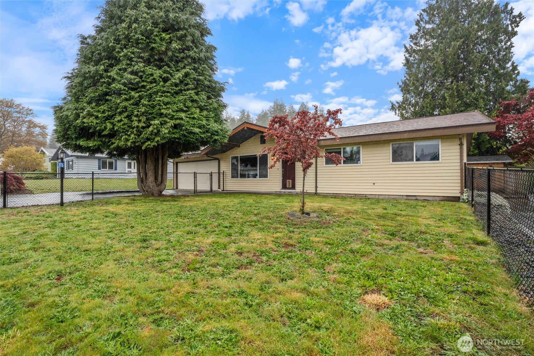 3876 Northeast Pinecone Drive Bremerton, WA 98310 - Photo 2 of 27 a front view of a house with a garden