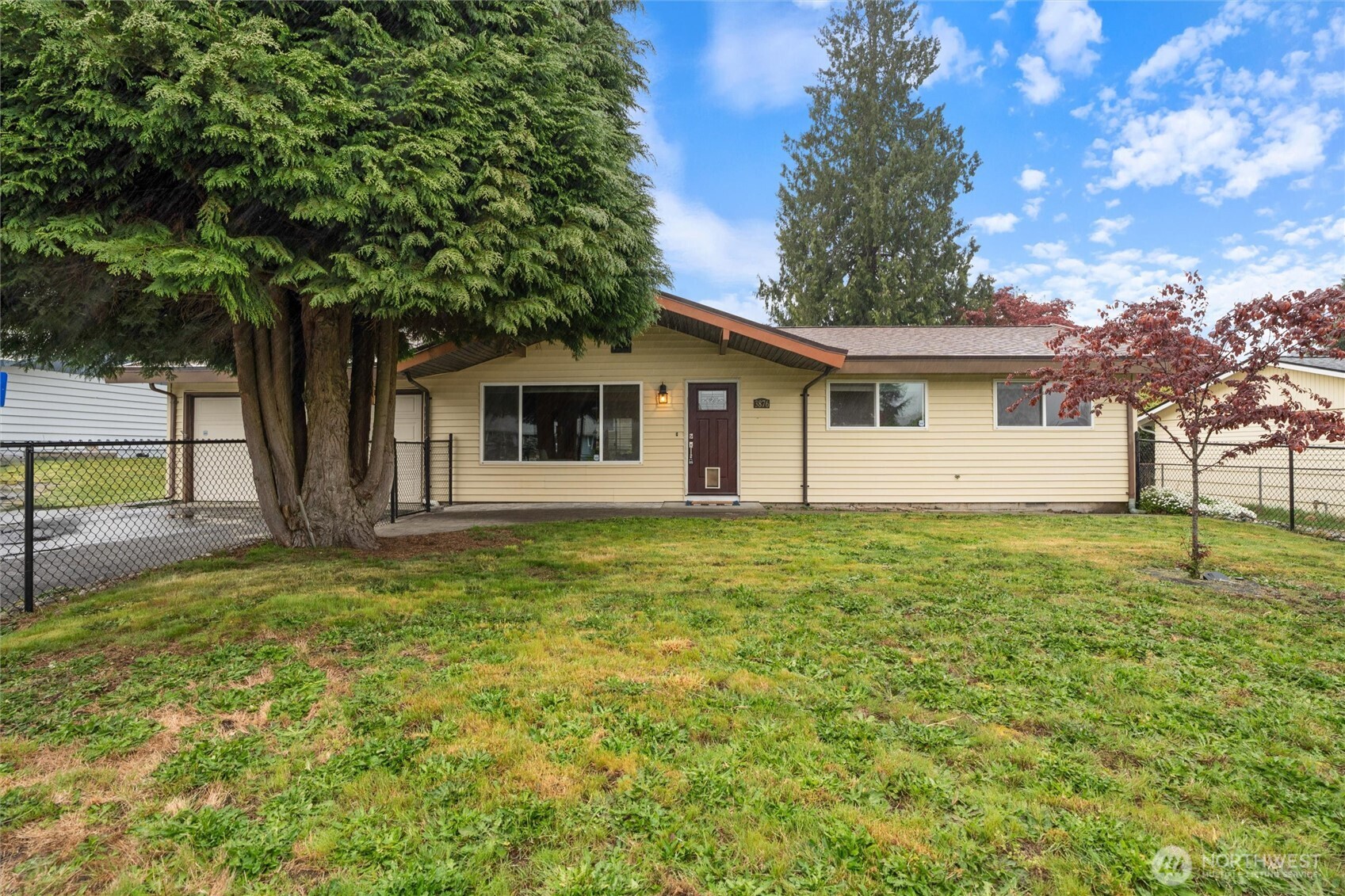 3876 Northeast Pinecone Drive Bremerton, WA 98310 - Photo 3 of 27 a house with trees in the background