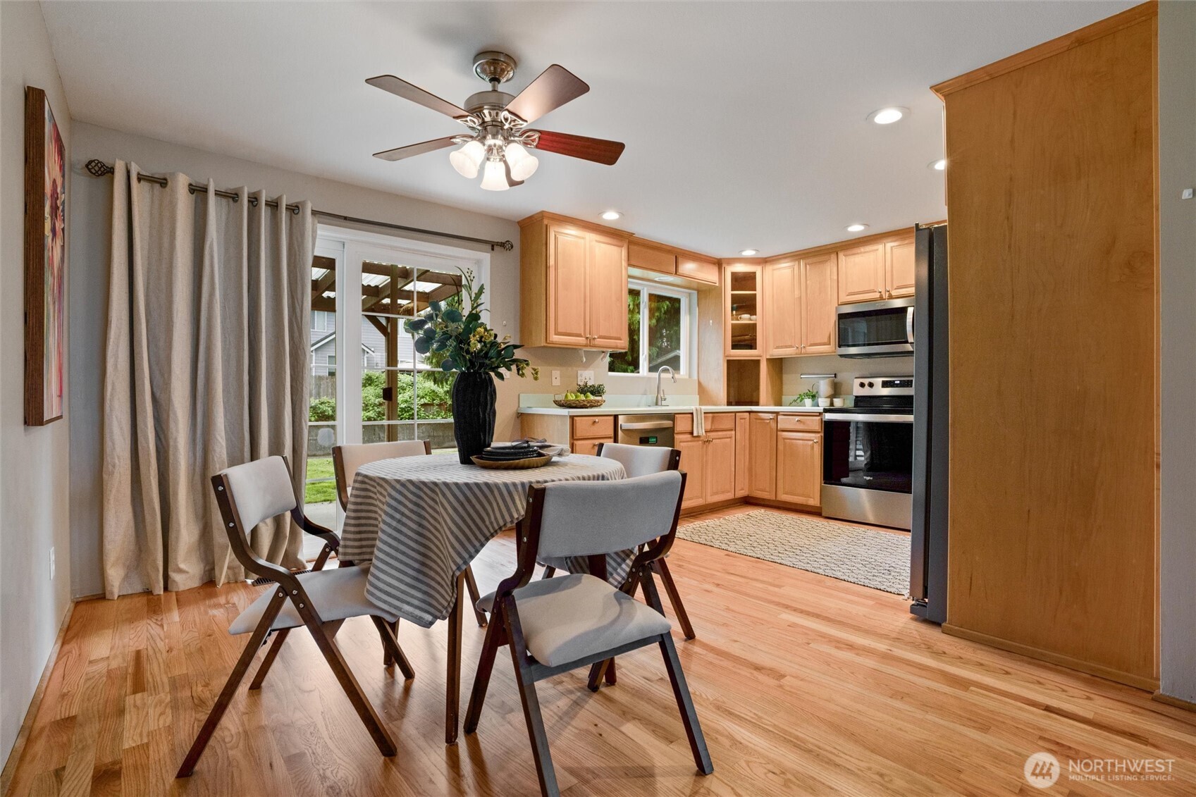 3876 Northeast Pinecone Drive Bremerton, WA 98310 - Photo 9 of 27 a view of a dining room with furniture window and wooden floor