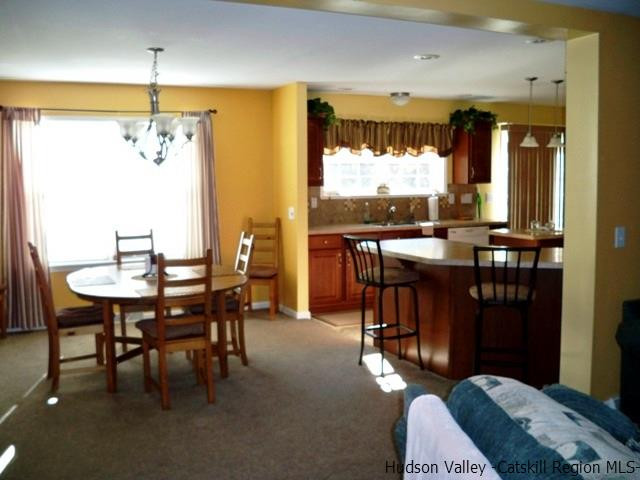 548 Carroll Hinkley Road Roxbury, NY 12474 - Photo 18 of 35 a dining room with furniture a chandelier and window