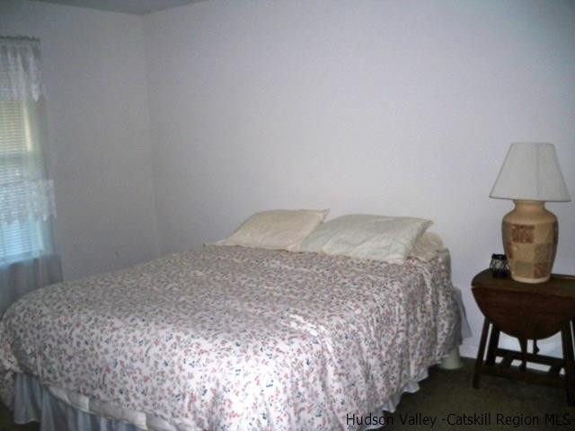 548 Carroll Hinkley Road Roxbury, NY 12474 - Photo 20 of 35 a bedroom with a bed and a lamp on table