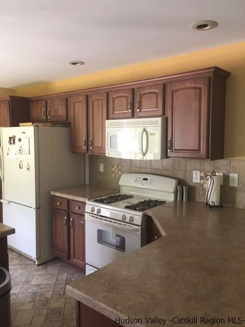 548 Carroll Hinkley Road Roxbury, NY 12474 - Photo 23 of 35 a kitchen with stainless steel appliances granite countertop a stove a sink and a refrigerator