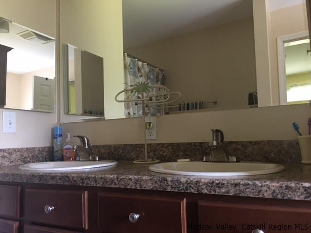 548 Carroll Hinkley Road Roxbury, NY 12474 - Photo 28 of 35 a bathroom with a granite countertop sink and a mirror