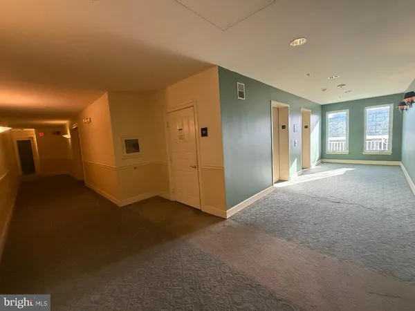 a view of a room with window and a ceiling fan