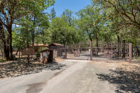 a view of a backyard with wooden fence and floor