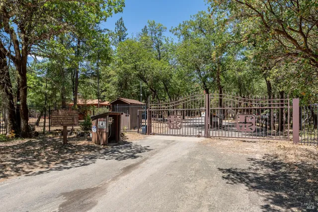 a view of a backyard with wooden fence and floor