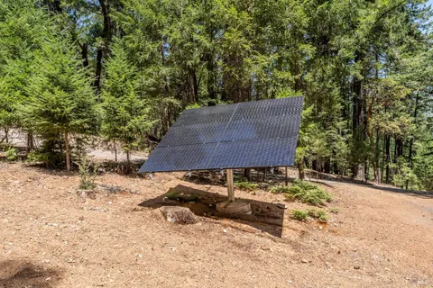 a backyard of a house with table and chairs