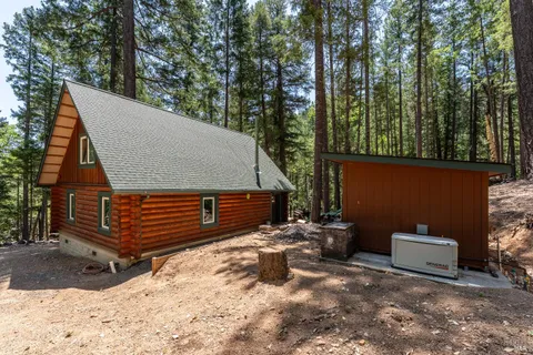 a view of a house with a yard covered in snow