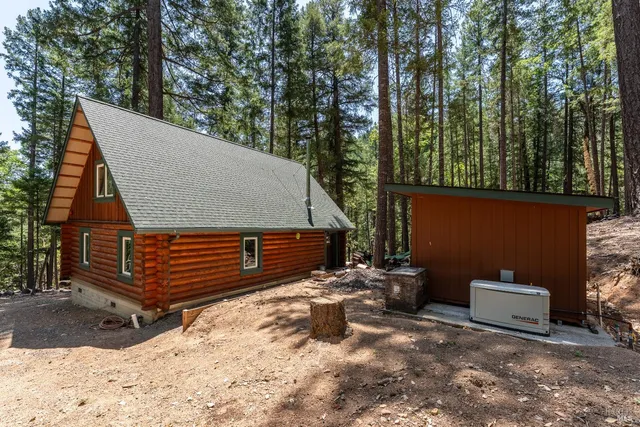 a view of a house with a yard covered in snow