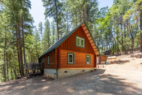 a view of backyard with deck and outdoor seating