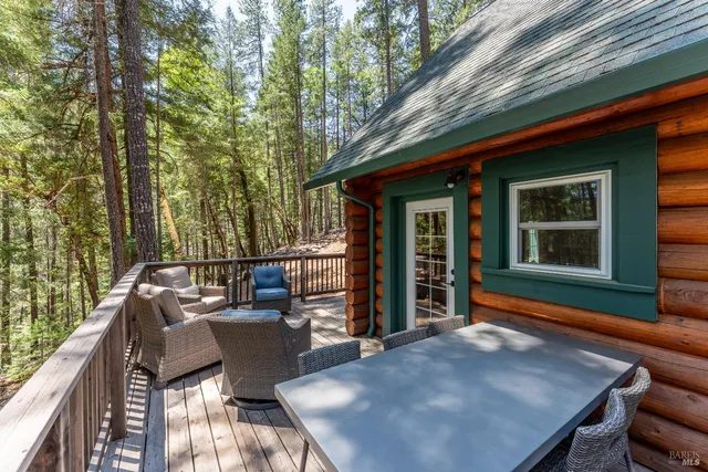 a balcony with wooden floor and outdoor seating