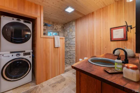 a view of a kitchen with a sink and a washer