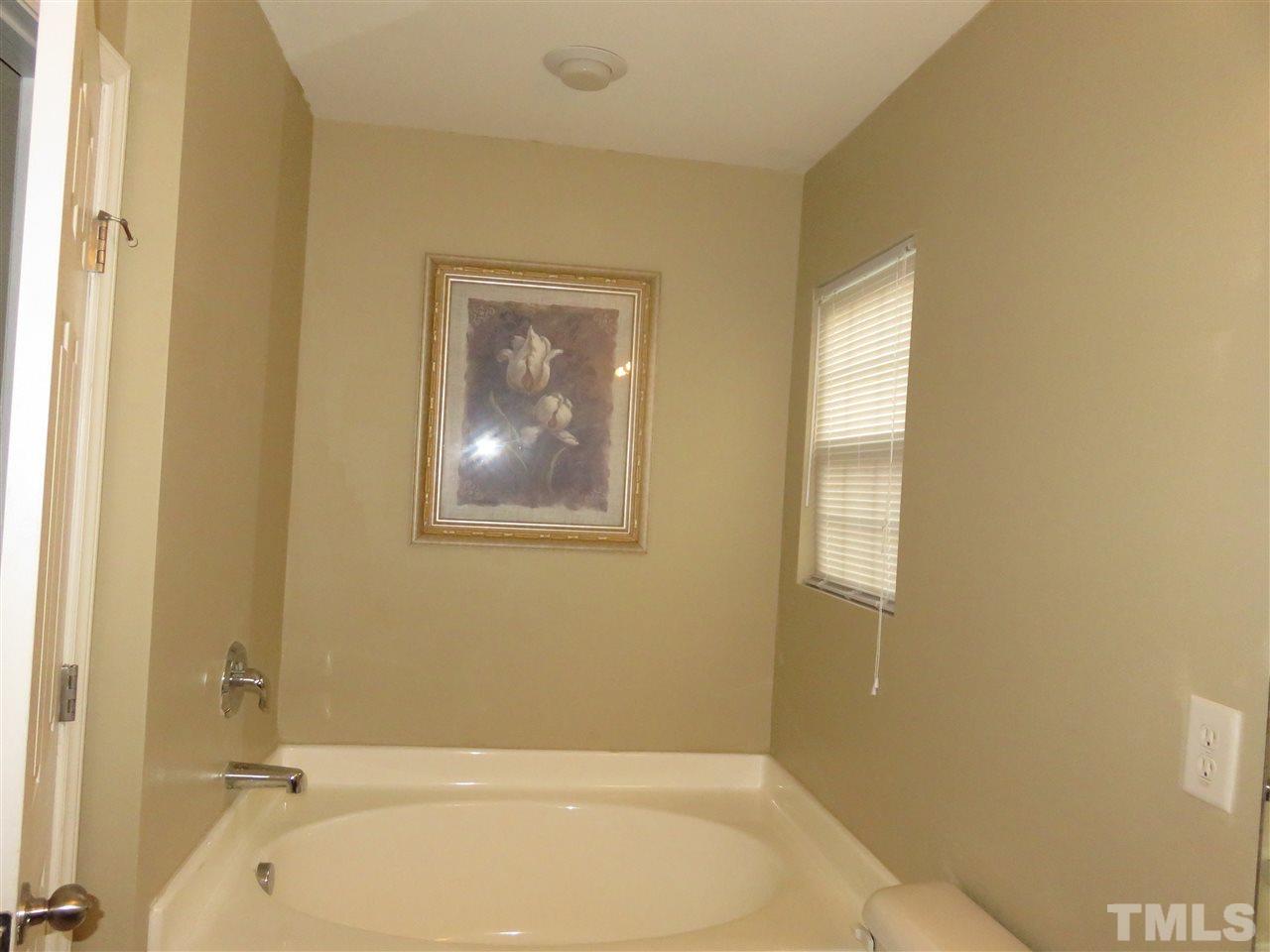 4124 Dalcross Road Raleigh, NC 27610 - Photo 12 of 14 a bathroom with a tub and shower