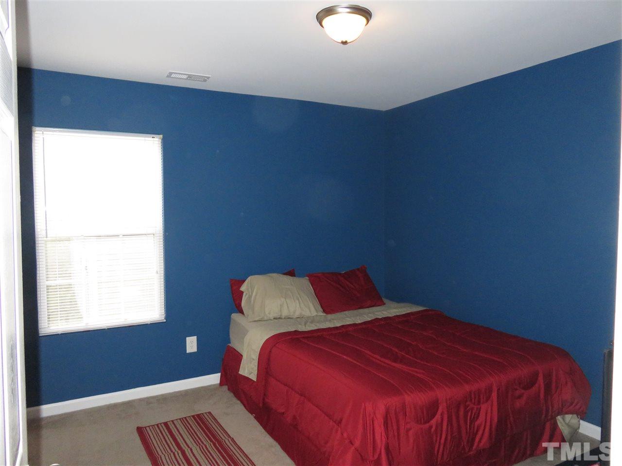 4124 Dalcross Road Raleigh, NC 27610 - Photo 13 of 14 a bedroom with a bed and a window
