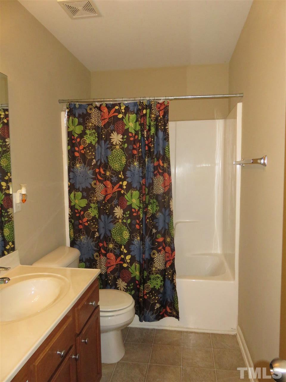 4124 Dalcross Road Raleigh, NC 27610 - Photo 14 of 14 a bathroom with a granite countertop sink toilet and shower