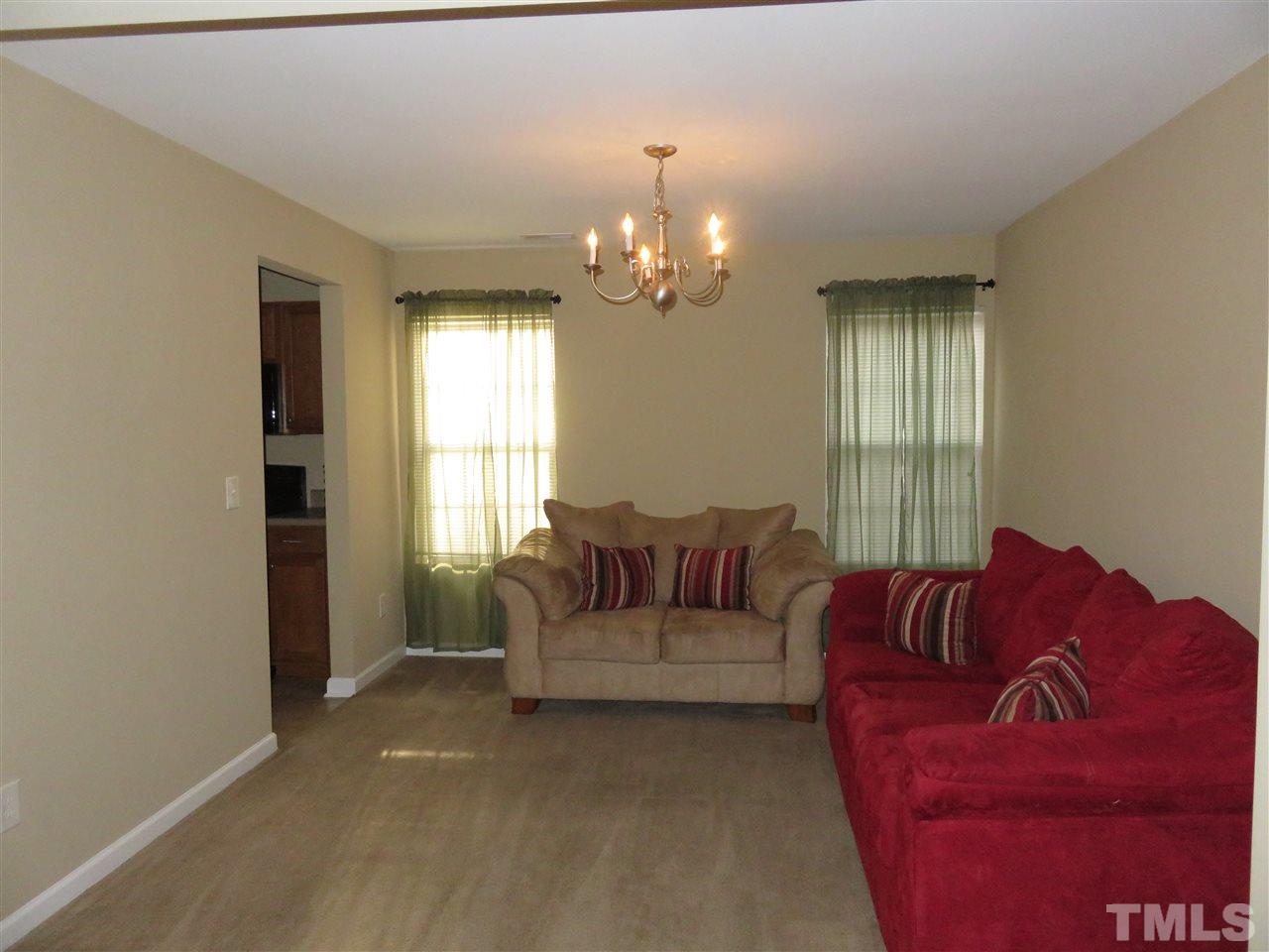 4124 Dalcross Road Raleigh, NC 27610 - Photo 3 of 14 a living room with furniture and a chandelier