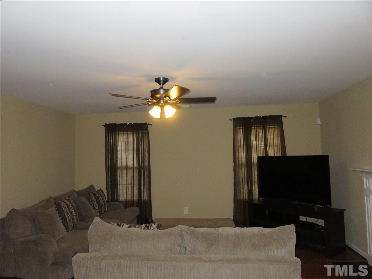 4124 Dalcross Road Raleigh, NC 27610 - Photo 5 of 14 a bedroom with a bed and a flat screen tv