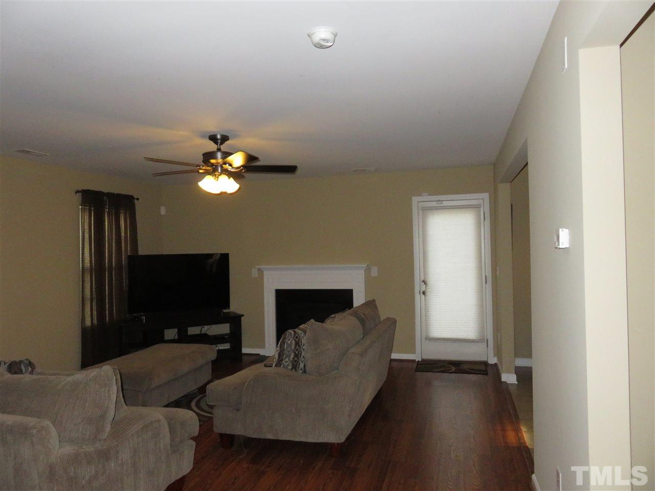 4124 Dalcross Road Raleigh, NC 27610 - Photo 6 of 14 a living room with furniture and a flat screen tv