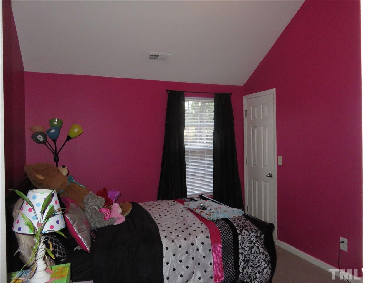 4124 Dalcross Road Raleigh, NC 27610 - Photo 8 of 14 a bed room with a bed and a window