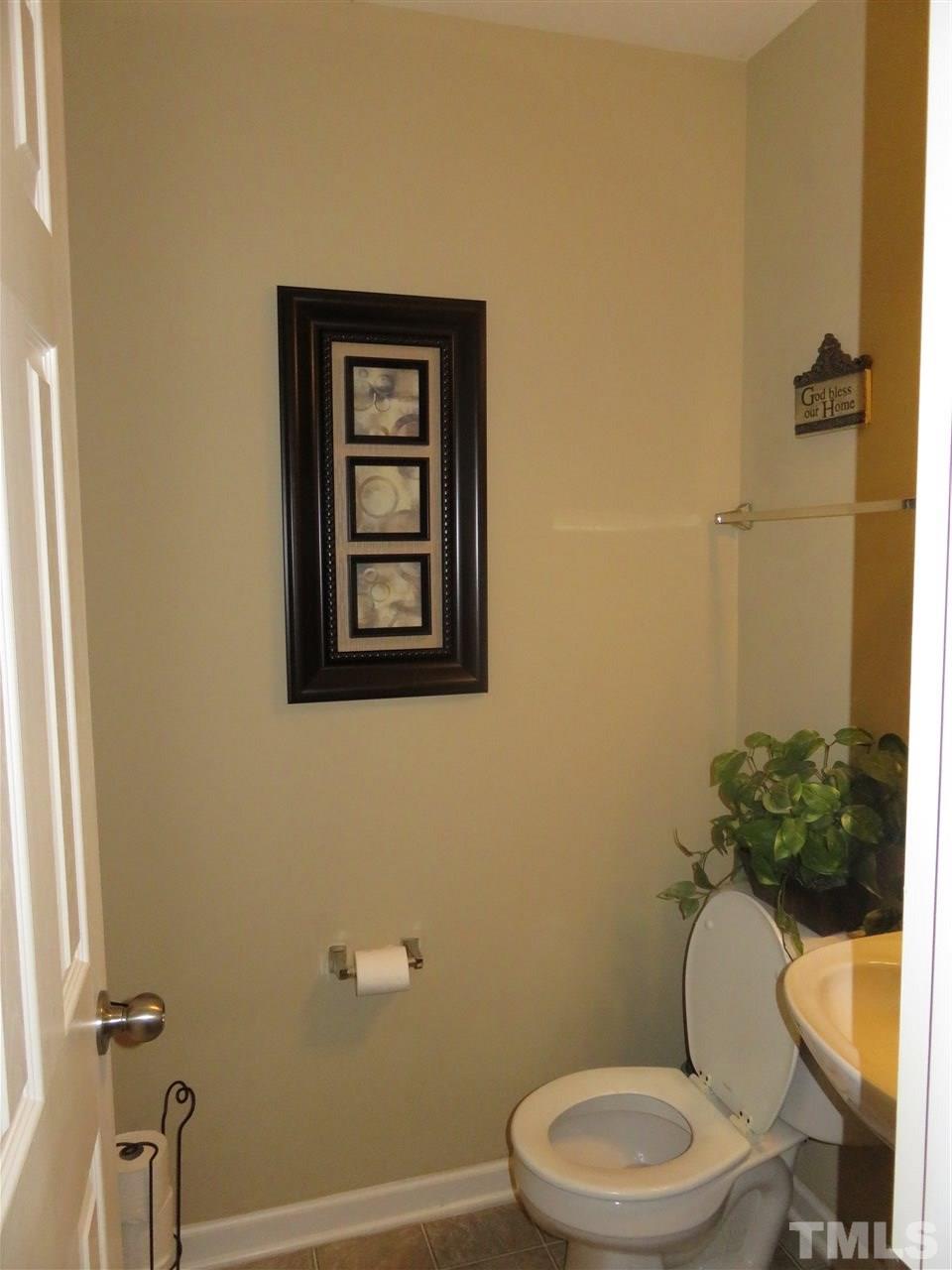 4124 Dalcross Road Raleigh, NC 27610 - Photo 9 of 14 a white toilet sitting next to a shower