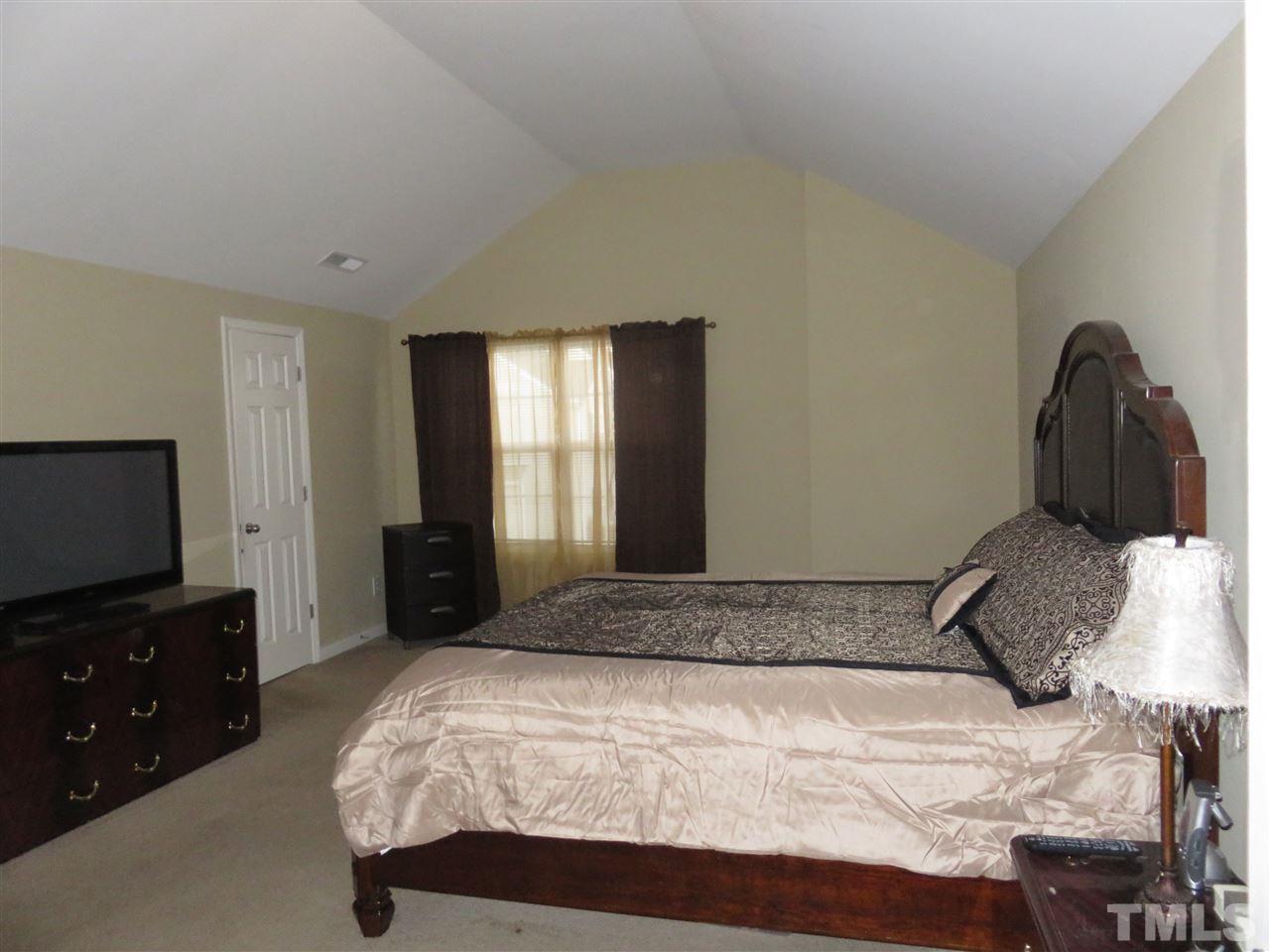 4124 Dalcross Road Raleigh, NC 27610 - Photo 10 of 14 a bedroom with a bed and a flat screen tv
