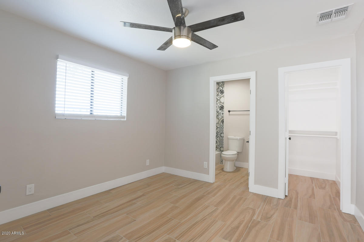 1817 East Alameda Drive Tempe, AZ 85282 - Photo 13 of 31 wooden floor in an empty room with a window