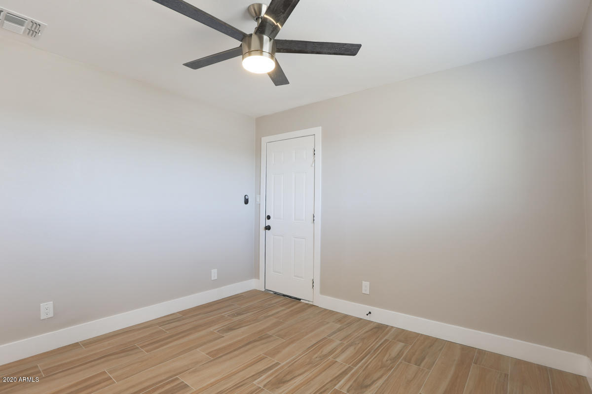 1817 East Alameda Drive Tempe, AZ 85282 - Photo 14 of 31 an empty room with wooden floor and a ceiling fan