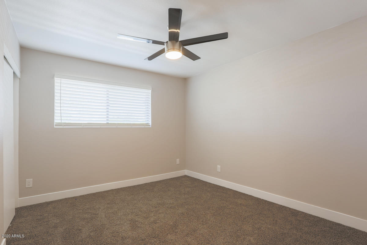 1817 East Alameda Drive Tempe, AZ 85282 - Photo 16 of 31 an empty room with a window and a fan