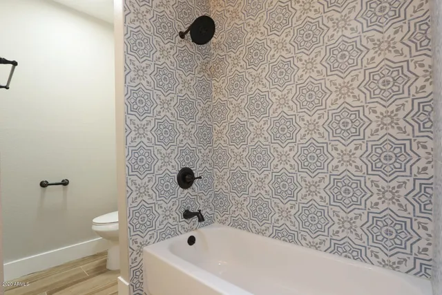 a bathroom with a bathtub and shower