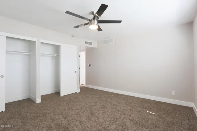 a view of a big room with a ceiling fan
