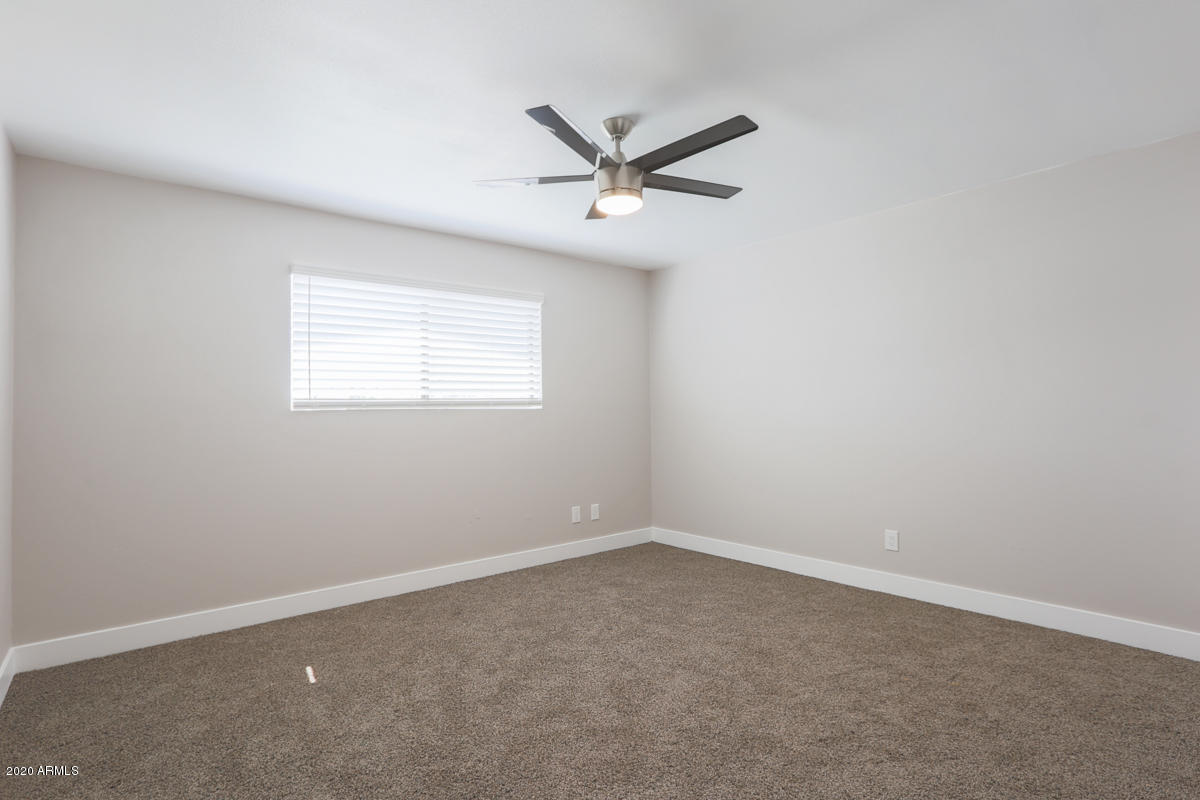 1817 East Alameda Drive Tempe, AZ 85282 - Photo 24 of 31 an empty room with a window and a fan