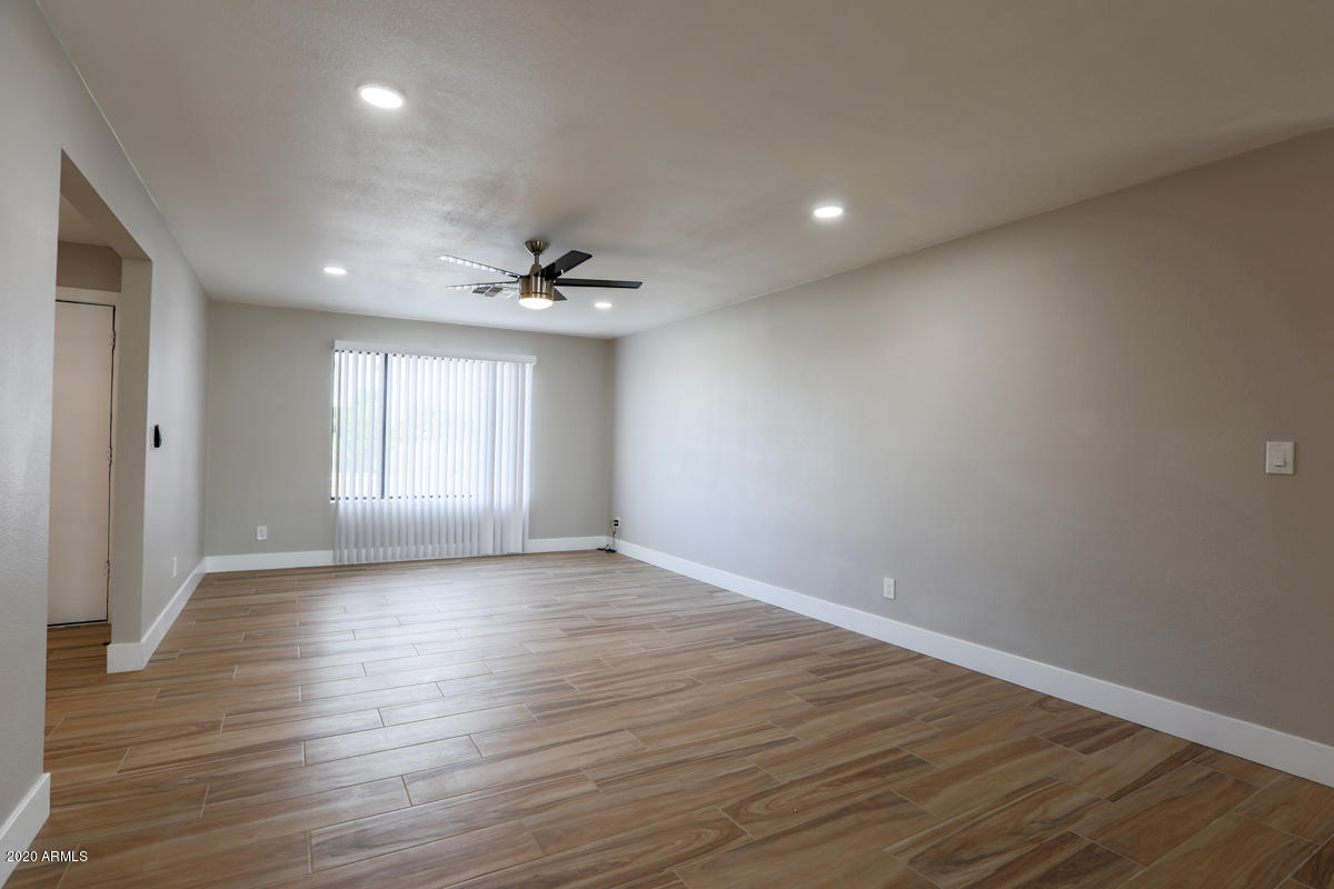 1817 East Alameda Drive Tempe, AZ 85282 - Photo 3 of 31 a view of an empty room with wooden floor and a window