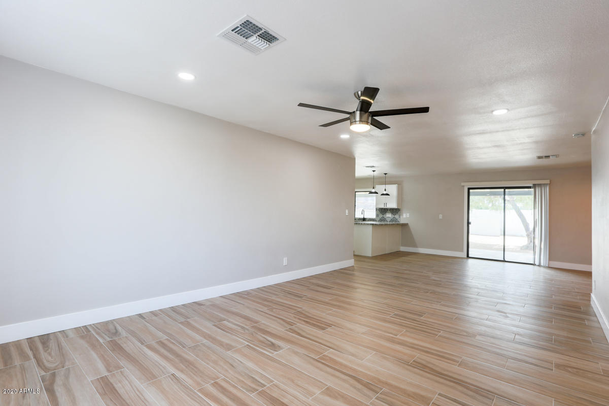 1817 East Alameda Drive Tempe, AZ 85282 - Photo 5 of 31 an empty room with wooden floor and windows