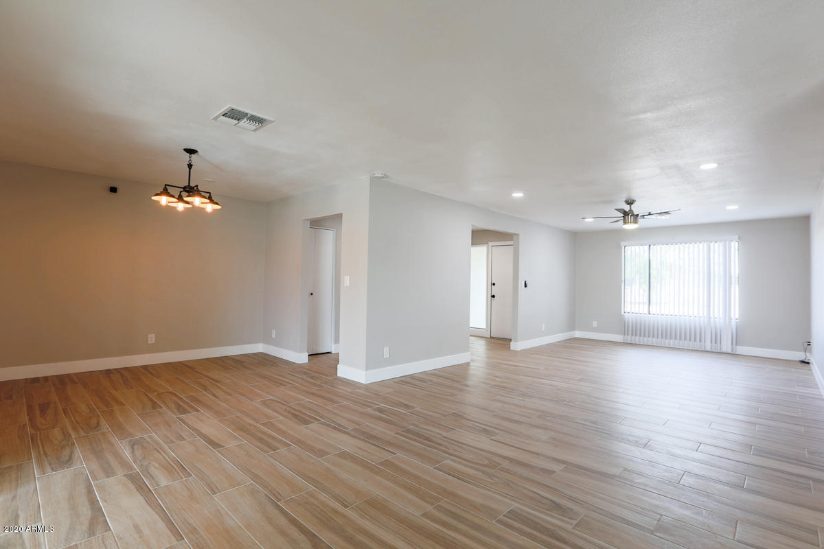 1817 East Alameda Drive Tempe, AZ 85282 - Photo 6 of 31 a view of an empty room with window and wooden floor