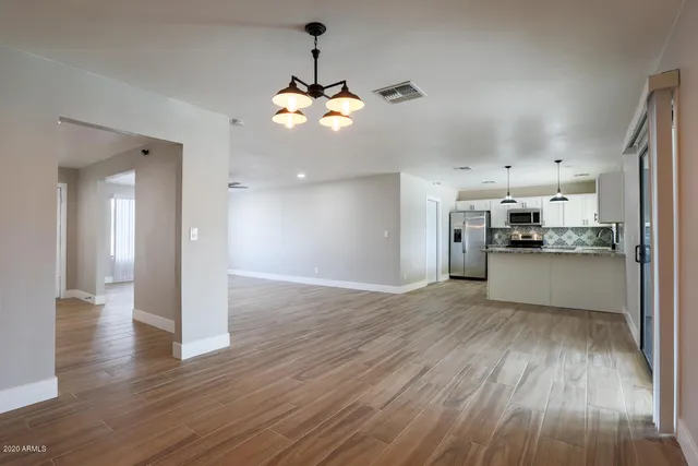 a view of a kitchen with a wooden floor and a kitchen