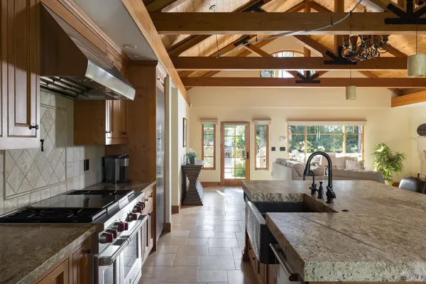 a kitchen with sink stove and cabinets