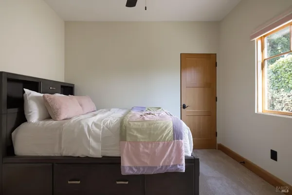 a bedroom with a bed and window