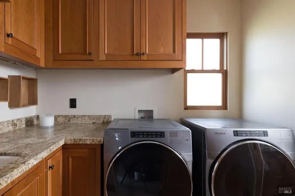 a view of a kitchen with washer and dryer