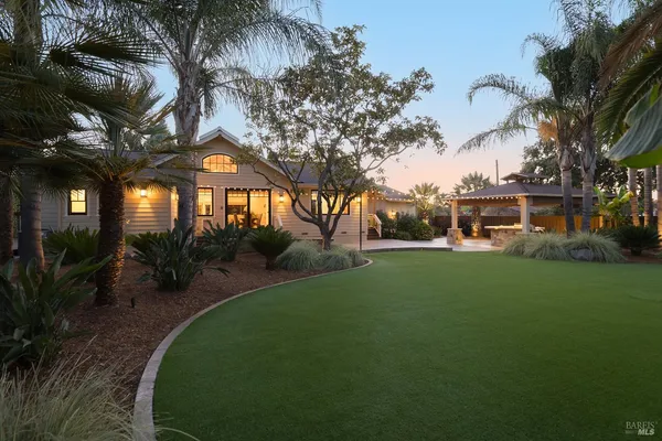 a view of a house with a backyard