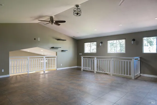 a room with wooden floor and windows