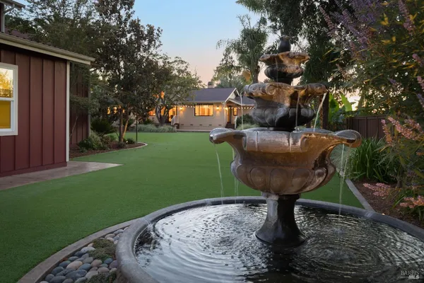 a view of a house with pool and a yard