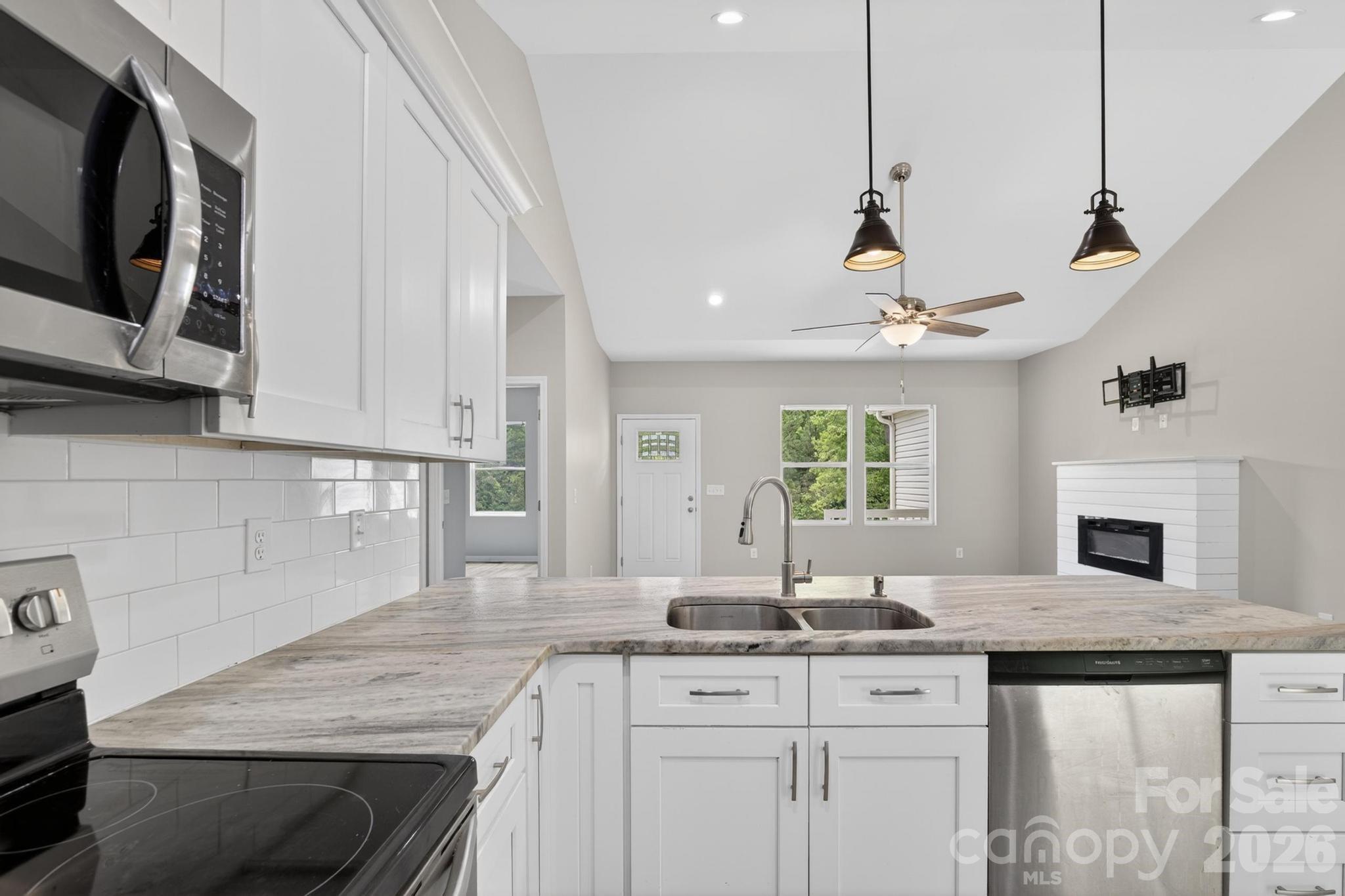 2119 South Road Morganton, NC 28655 - Photo 21 of 47 a kitchen with granite countertop a sink a counter space appliances and cabinets