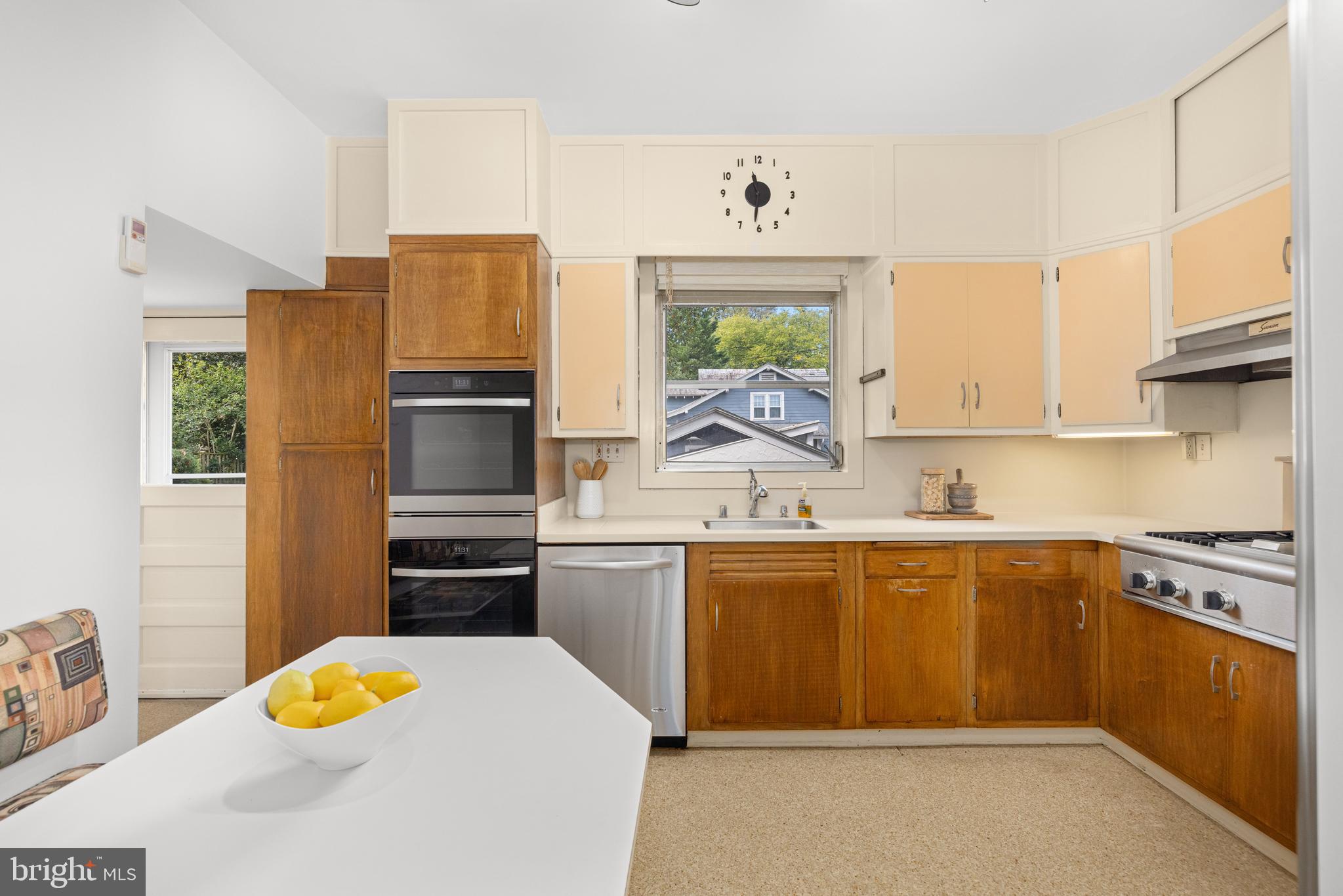 5410 39th Street Northwest Washington, DC 20015 - Photo 6 of 28 a kitchen with stainless steel appliances granite countertop a sink stove and refrigerator