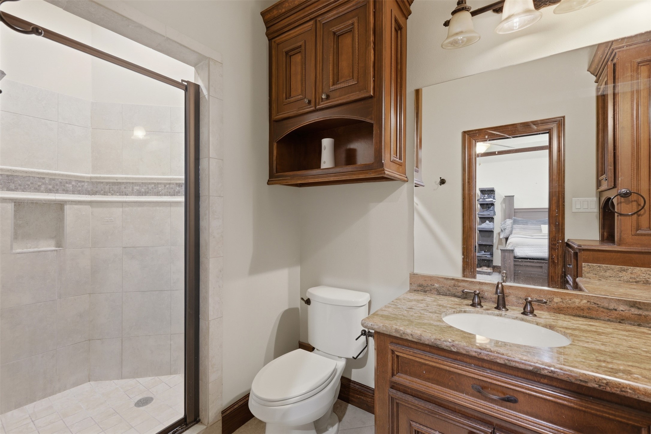 14 Post Shadow Estate Drive Spring, TX 77389 - Photo 30 of 49 a bathroom with a granite countertop toilet sink and mirror