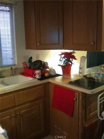 a kitchen with a sink cabinets and window
