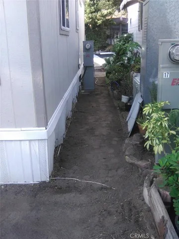 a view of a pathway of a house with wooden fence
