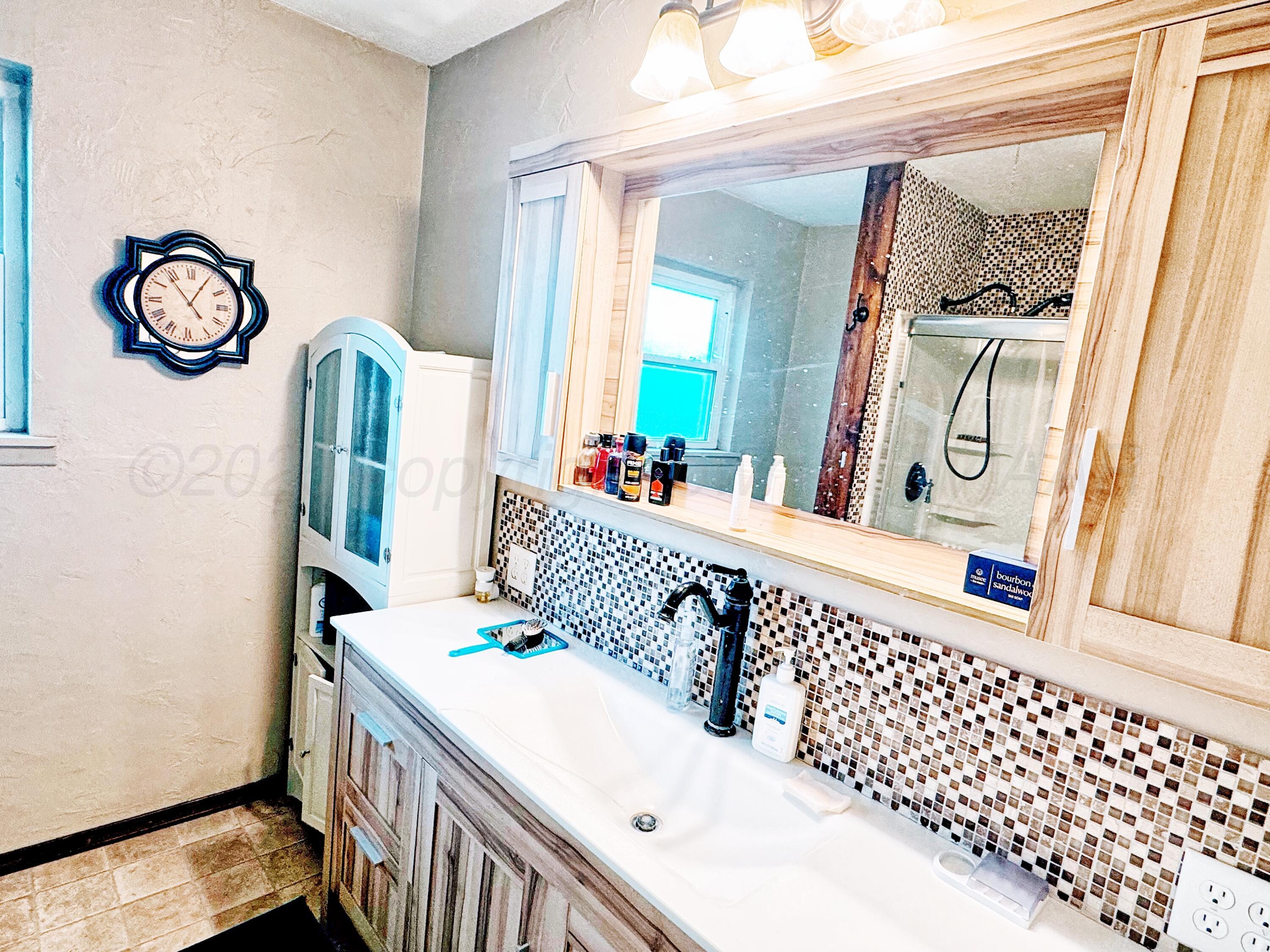 3210 South Ash Street Perryton, TX 79070 - Photo 12 of 28 a bedroom with a bed and a window