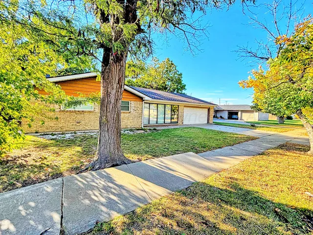 a view of house with yard