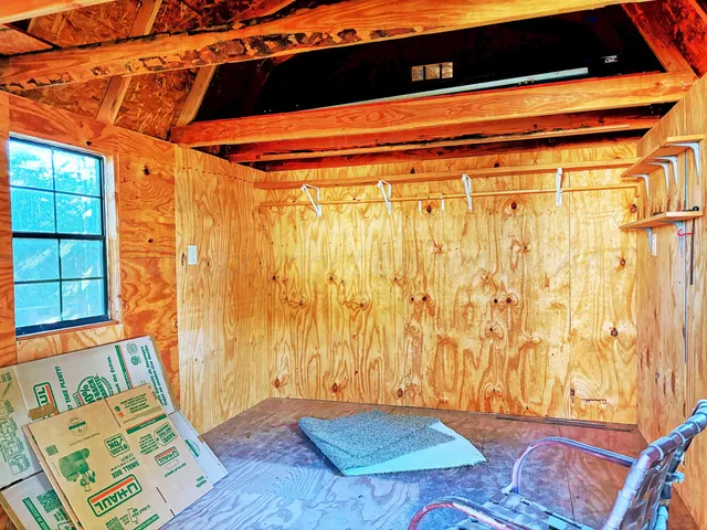 a view of a backyard with barn and wooden fence