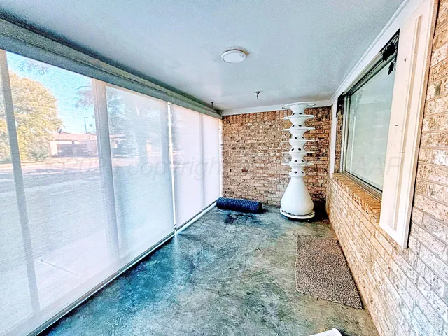 a view of an empty room and a window